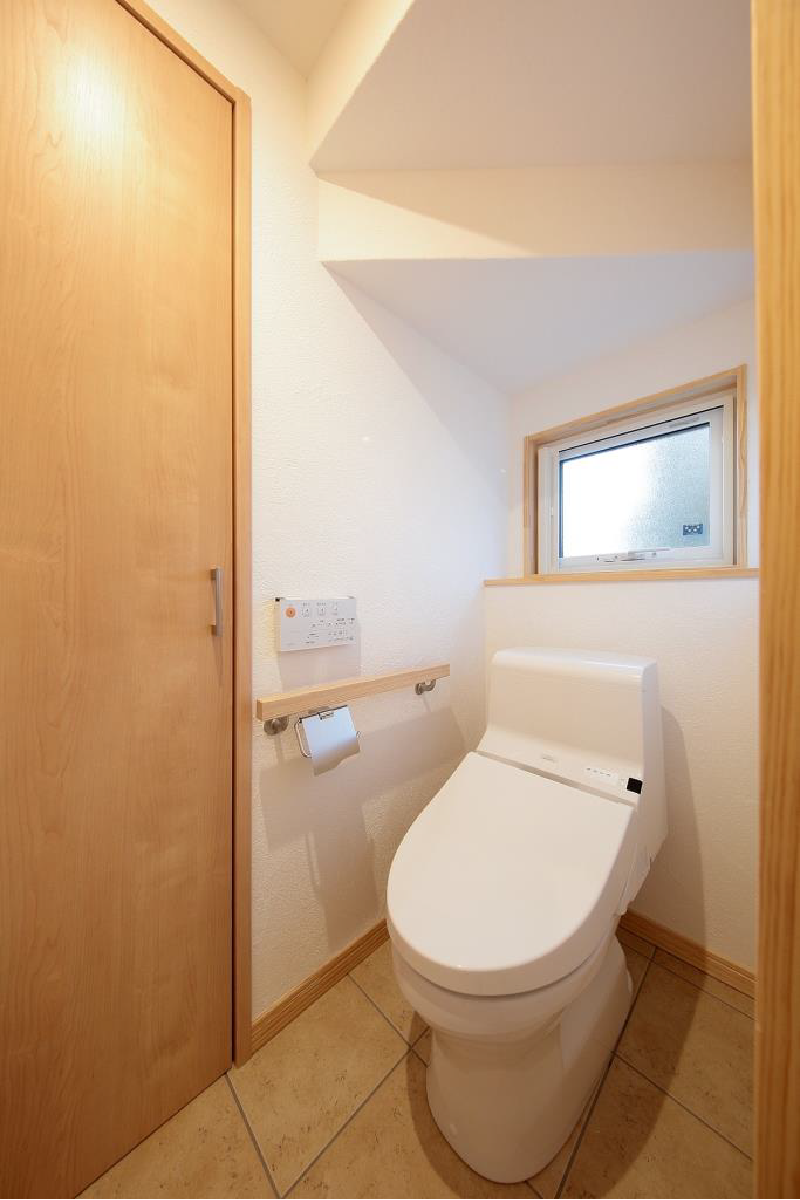 階段下のトイレ。暗くならないよう窓を設置